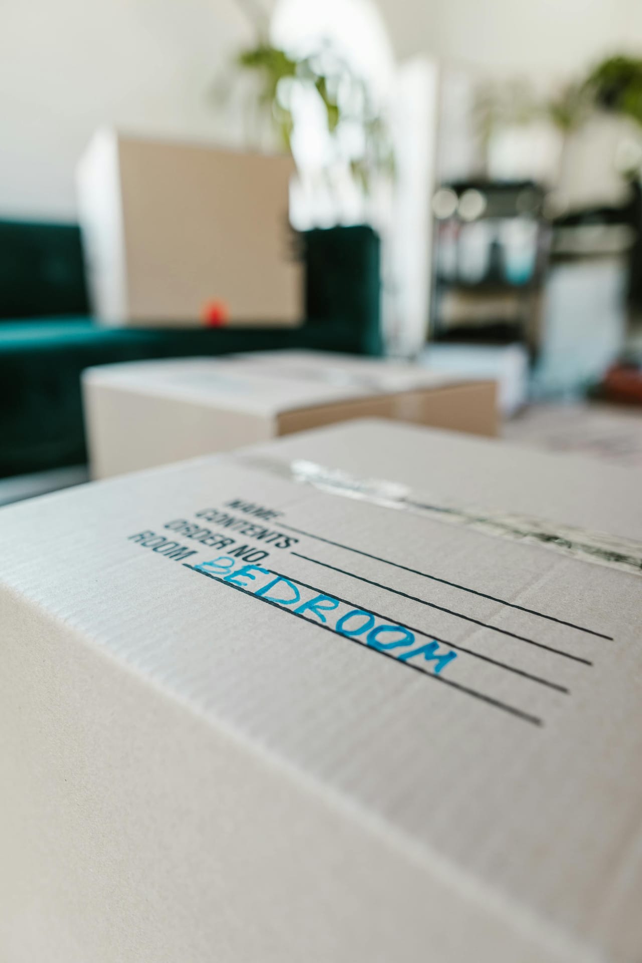 Cardboard box labeled "Bedroom" placed indoors, ready for moving — itemized billing keeps room-by-room loads transparent.